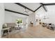 Bright and airy living room with hardwood floors, vaulted ceilings, fireplace, and sliding door to the backyard at 7319 E Rose Ln, Scottsdale, AZ 85250