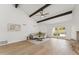 Spacious living room featuring a vaulted ceiling, hardwood floors, and sliding glass doors at 7319 E Rose Ln, Scottsdale, AZ 85250