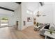 Open living space with hardwood floors, fireplace, and a view of kitchen at 7319 E Rose Ln, Scottsdale, AZ 85250
