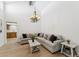 Comfortable living space featuring vaulted ceilings, ample seating, chandelier, and view of the kitchen at 7319 E Rose Ln, Scottsdale, AZ 85250