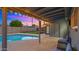 Backyard oasis with inviting pool, covered patio, and string lights for evening ambiance at 7543 E Portland St, Scottsdale, AZ 85257