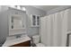 Bathroom featuring a white shower curtain, toilet, vanity, and small storage cabinet at 7543 E Portland St, Scottsdale, AZ 85257
