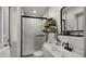 Modern bathroom with tiled shower, floating shelves and sleek vanity with a vessel sink at 7543 E Portland St, Scottsdale, AZ 85257