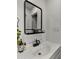Bathroom with a modern mirror, white sink, dark faucet and modern decor at 7543 E Portland St, Scottsdale, AZ 85257