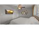 This bedroom has a ceiling fan, television, closet, window, and decorative wall hanging at 7543 E Portland St, Scottsdale, AZ 85257