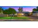 Charming single story home with fresh green lawn, landscape lighting and mature shade tree at 7543 E Portland St, Scottsdale, AZ 85257