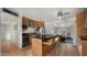 Well-lit kitchen with stainless appliances, breakfast bar, and adjacent casual dining area at 7543 E Portland St, Scottsdale, AZ 85257