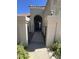 Charming entryway with iron gate, stucco pillars, and arched entrance, creating a welcoming feel at 7725 W Mcrae W Way, Glendale, AZ 85308