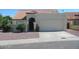 Charming single-story home featuring a stucco exterior, red tile roof, and desert landscaping at 7725 W Mcrae W Way, Glendale, AZ 85308