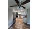 Updated kitchen featuring stainless steel appliances, granite countertops, and new wood flooring at 7725 W Mcrae W Way, Glendale, AZ 85308