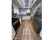 Full kitchen view with stainless steel appliances, updated cabinetry, and modern flooring at 7725 W Mcrae W Way, Glendale, AZ 85308