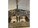 Stainless steel double sink with granite countertop in a bright and clean kitchen at 7725 W Mcrae W Way, Glendale, AZ 85308
