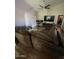 Spacious living room with a large sofa, vaulted ceiling, and ceiling fan at 7725 W Mcrae W Way, Glendale, AZ 85308
