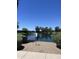 Picturesque pond featuring a soothing fountain surrounded by mature trees, creating a peaceful outdoor scene at 7725 W Mcrae W Way, Glendale, AZ 85308