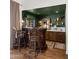 Charming bar area with custom wood cabinets, unique stools, and decorative lighting features at 8049 E Serene St, Carefree, AZ 85377