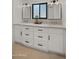 Bright bathroom featuring double sinks, white cabinets, and a view out the window at 8049 E Serene St, Carefree, AZ 85377
