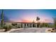 Welcoming desert home featuring a circular driveway, pergola-covered entrance, and meticulously maintained desert landscaping at 8049 E Serene St, Carefree, AZ 85377