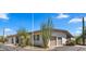 View of the home's exterior featuring a two-car garage and desert landscaping at 8049 E Serene St, Carefree, AZ 85377