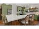 A well-appointed kitchen features green cabinetry, stainless steel appliances, and a breakfast bar with seating at 8049 E Serene St, Carefree, AZ 85377