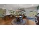 Charming kitchen with green cabinetry, a round dining table, and hardwood floors adjacent to an open door at 8049 E Serene St, Carefree, AZ 85377