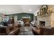 Cozy living room with a brick fireplace, comfortable seating, hardwood floors, and elegant decor creating a warm ambiance at 8049 E Serene St, Carefree, AZ 85377