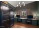 Home office featuring custom built-in desks, chairs, and closet for storage at 8049 E Serene St, Carefree, AZ 85377
