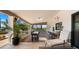 Spacious covered patio with a dining area, bar seating, and views of the lush desert landscaping at 8049 E Serene St, Carefree, AZ 85377