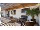A cozy patio setting features comfortable seating, overhead shade, and desert landscaping at 8049 E Serene St, Carefree, AZ 85377