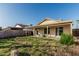 View of the backyard featuring perimeter fencing, a lawn, and a covered patio at 8566 N 108Th Ln, Peoria, AZ 85345