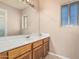 Bathroom with tan walls has a large vanity and mirror plus a separate shower enclosure at 8566 N 108Th Ln, Peoria, AZ 85345