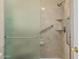 Bright shower with safety bars and built-in shelves is accessible through a glass door at 8566 N 108Th Ln, Peoria, AZ 85345