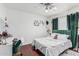 Bright bedroom has hardwood floors, a bed with decorative pillows, and a desk space at 8566 N 108Th Ln, Peoria, AZ 85345