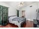 Bedroom with wood floors and a ceiling fan is brightened by a large window at 8566 N 108Th Ln, Peoria, AZ 85345