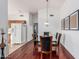 Bright dining area with a glass table, comfortable seating, and a seamless flow to the kitchen at 8566 N 108Th Ln, Peoria, AZ 85345