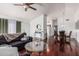 Open-concept living room with rich wood floors and seamless connection to the dining area at 8566 N 108Th Ln, Peoria, AZ 85345