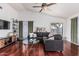 Cozy living room featuring rich wood floors, a vaulted ceiling, and natural light at 8566 N 108Th Ln, Peoria, AZ 85345