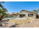 Back yard with a covered patio and a sparkling blue swimming pool at 1037 E Baylor Ln, Gilbert, AZ 85296