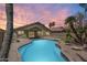 Private backyard featuring a sparkling pool, mature palm trees, and a covered patio, perfect for relaxation and entertainment at 1037 E Baylor Ln, Gilbert, AZ 85296