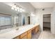 Spacious bathroom featuring a long vanity with double sinks and a large mirror at 1037 E Baylor Ln, Gilbert, AZ 85296