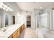 Bright bathroom with double vanity, and walk-in shower offers space and comfort at 1037 E Baylor Ln, Gilbert, AZ 85296