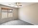 Comfortable bedroom with carpet, ceiling fan, and natural light from the window at 1037 E Baylor Ln, Gilbert, AZ 85296