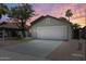 Charming single-story home exterior with desert landscaping and a two-car garage at 1037 E Baylor Ln, Gilbert, AZ 85296