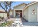 Home featuring a red front door, desert landscaping, and mature shade tree at 1037 E Baylor Ln, Gilbert, AZ 85296