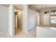 Bright hallway features neutral tile flooring and leads to the home's entryway at 1037 E Baylor Ln, Gilbert, AZ 85296