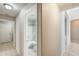 Hallway view leading to a full bathroom showcasing clean lines and modern fixtures at 1037 E Baylor Ln, Gilbert, AZ 85296