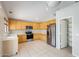 Bright kitchen features stainless steel appliances, light wood cabinets, and tile flooring at 1037 E Baylor Ln, Gilbert, AZ 85296