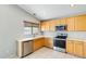 Bright kitchen features light wood cabinetry, stainless appliances, and a window above the sink at 1037 E Baylor Ln, Gilbert, AZ 85296