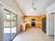 Bright kitchen features stainless steel appliances, light wood cabinets, tile flooring, and a sliding glass door at 1037 E Baylor Ln, Gilbert, AZ 85296