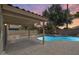 A covered patio extends living space outdoors, next to backyard pool at 1037 E Baylor Ln, Gilbert, AZ 85296