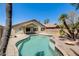 Backyard pool with a meticulously designed patio, lush landscaping, and tranquil desert surroundings at 1037 E Baylor Ln, Gilbert, AZ 85296